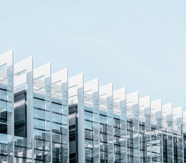 Modern glass building facade; illustrative image, not the announced LIXIL factory