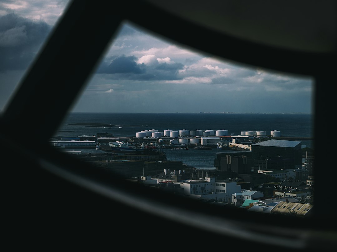 Oil storage tanks and industrial port infrastructure, illustrating global crude oil supply and shipping