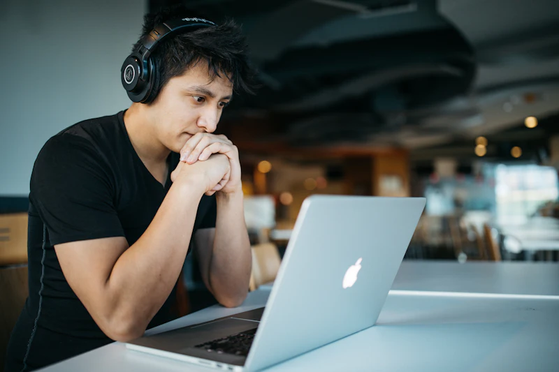 A student using a laptop while studying, illustrating how young people use AI for homework and learning.